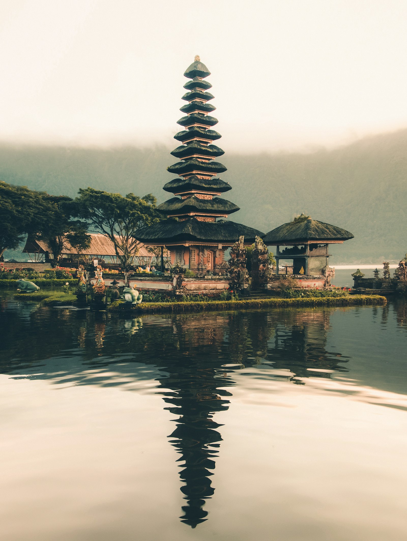 A Balinese water temple mirrored in the lake at dawn