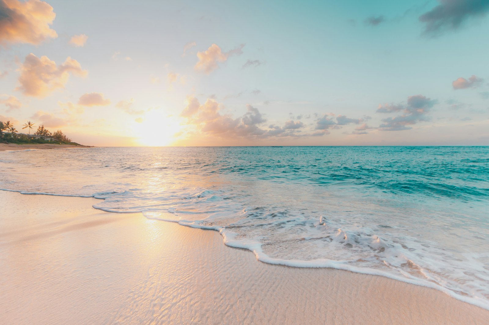 Surf running up an empty beach at sunrise